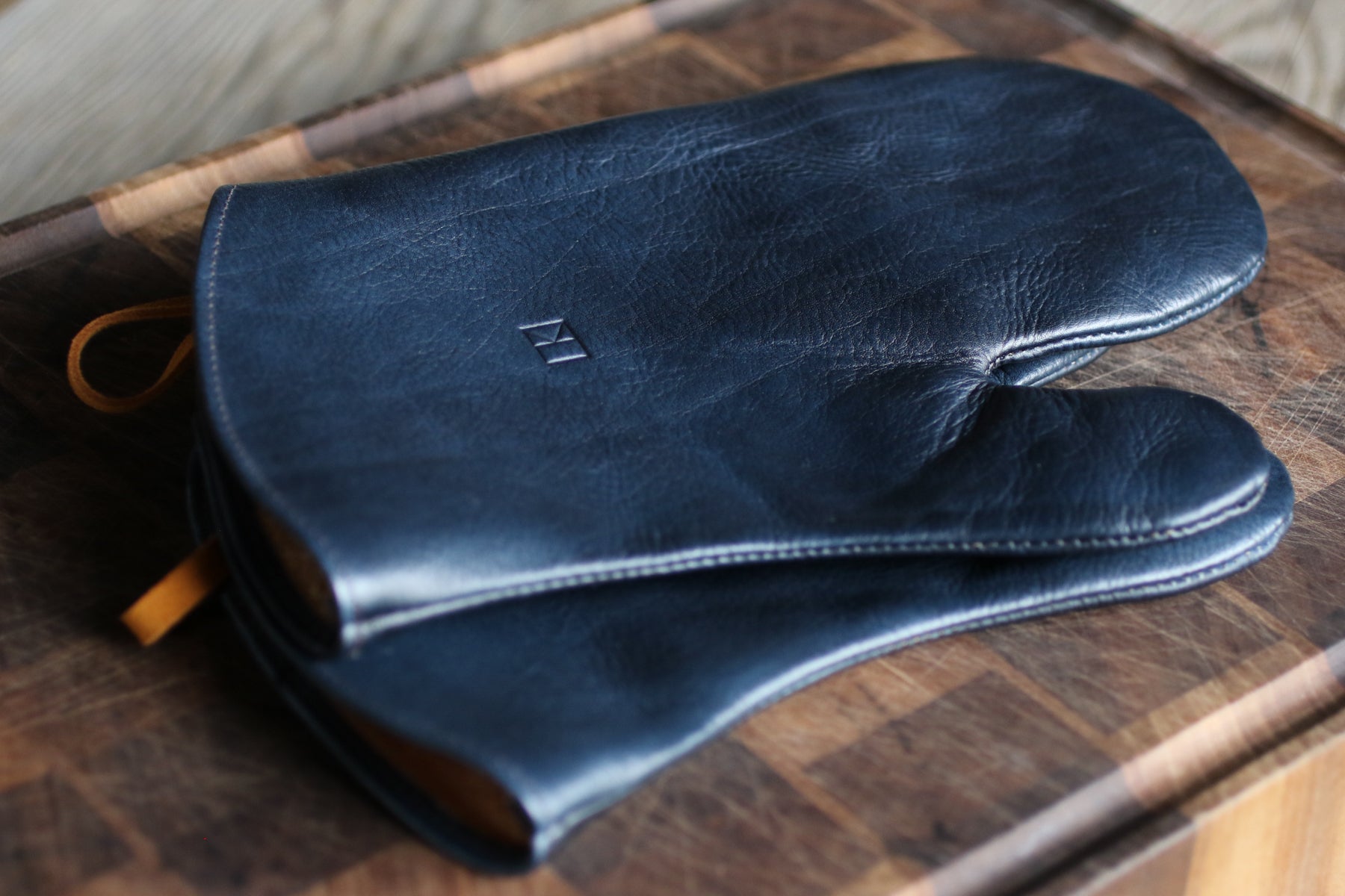 dark blue leather oven mitts