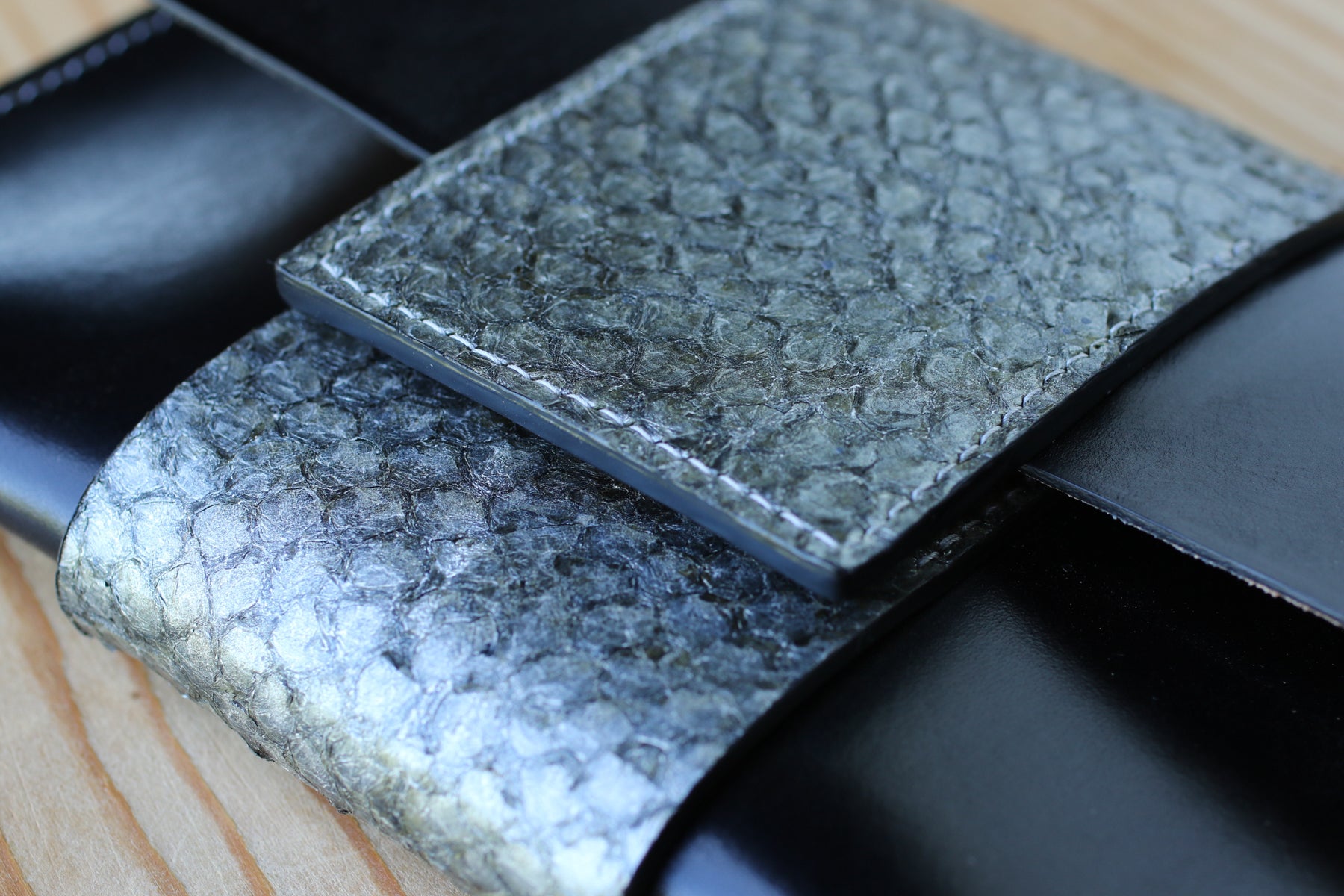 black leather and fish skin clutch