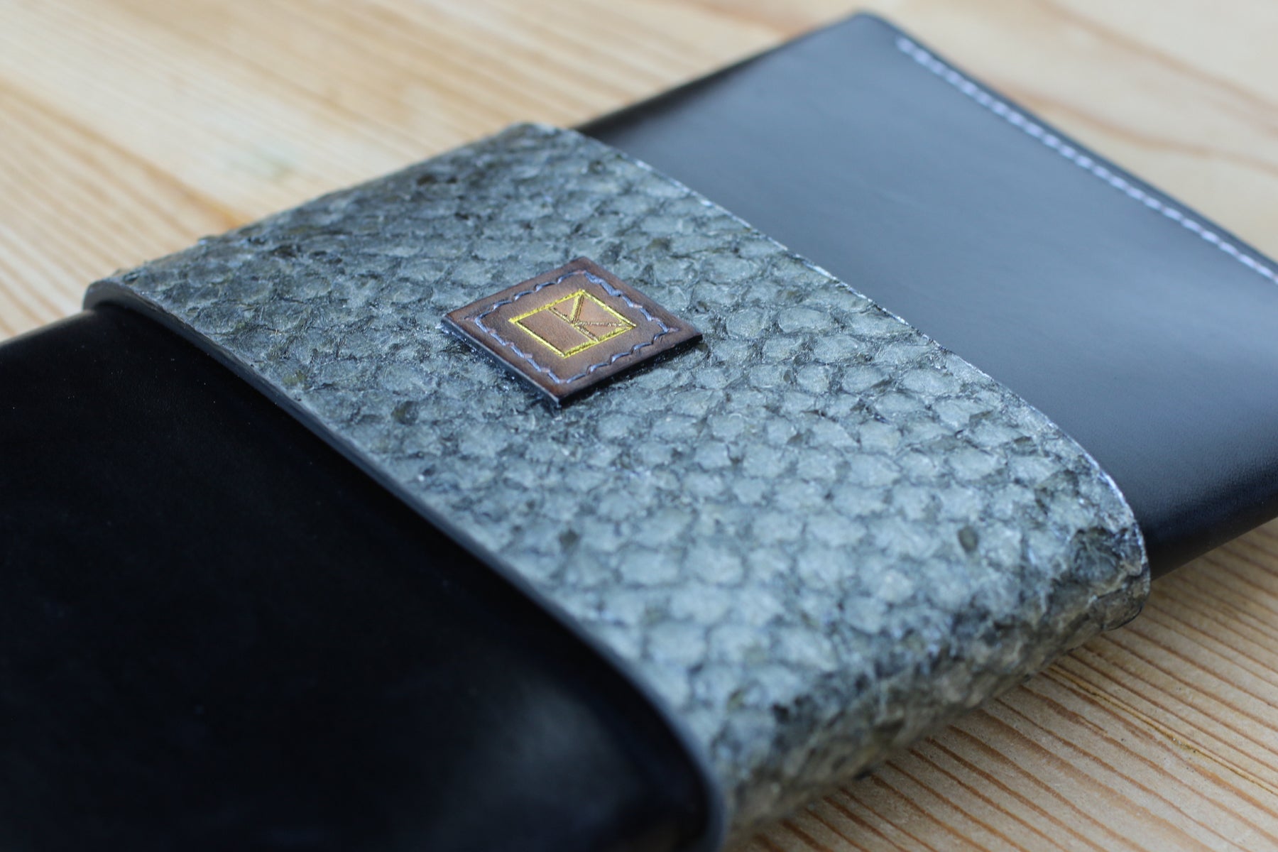 black leather and fish skin clutch