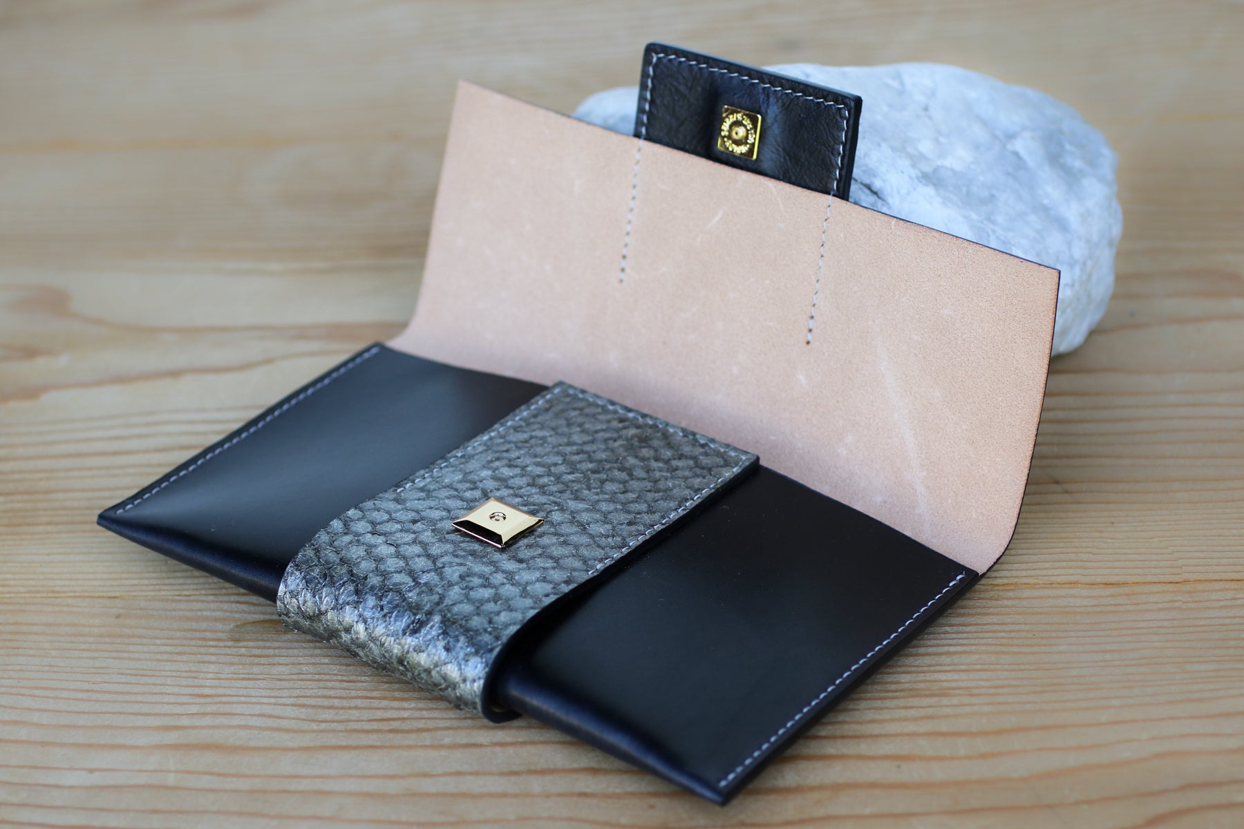 black leather and fish skin clutch