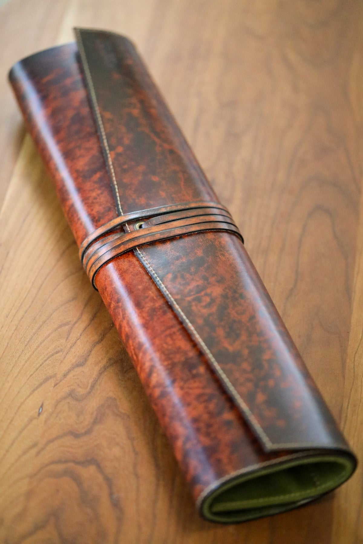 brown leather knife roll with green interior